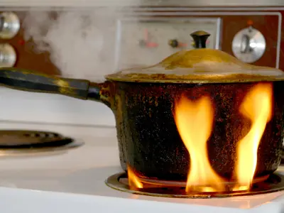 pot on stove that is catching on fire